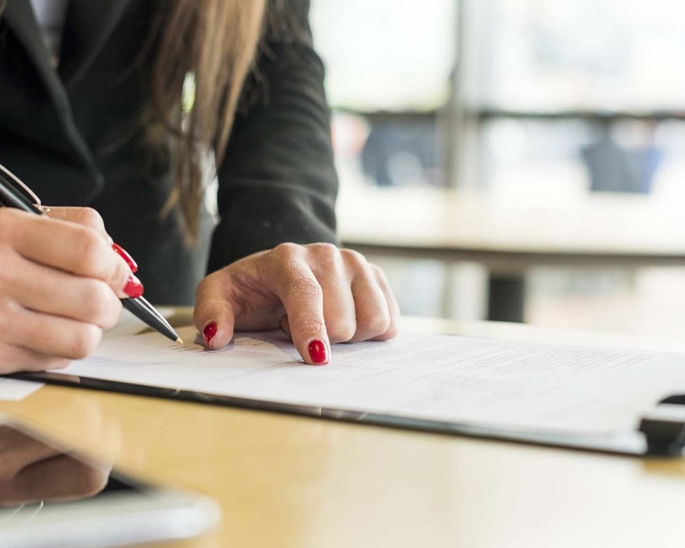 brunette-businesswoman-writing-document