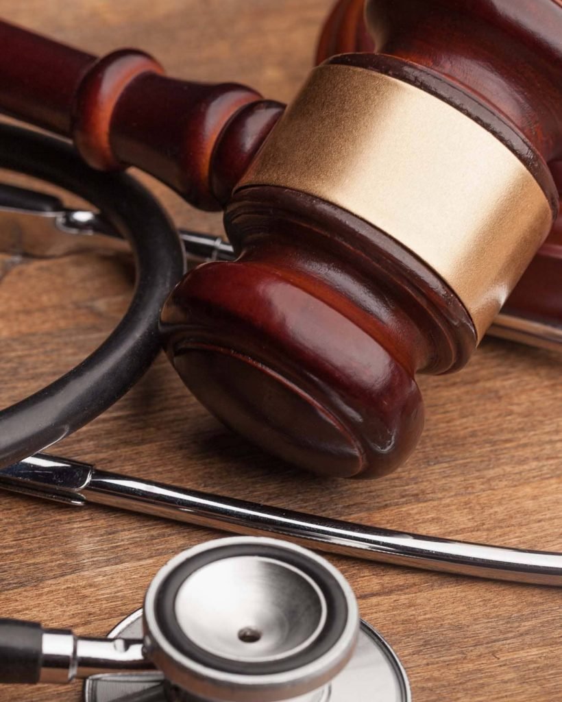 gavel-stethoscope-wooden-background